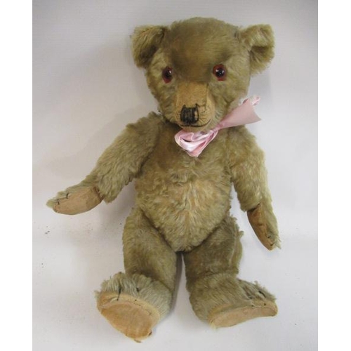 154 - An English teddy bear, possibly Farnell, with amber glass eyes, sewn nose, shaved snout, orange plus... 