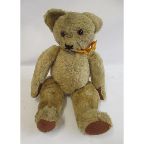 156 - A pre-war English teddy bear, with glass amber eyes, later sewn nose, light orange plush and felt pa... 