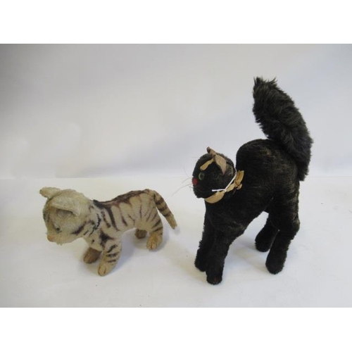 177 - Two Steiff cats, comprising a tabby with green glass eyes and a 1950s Schwarzer Kater with silver bu... 