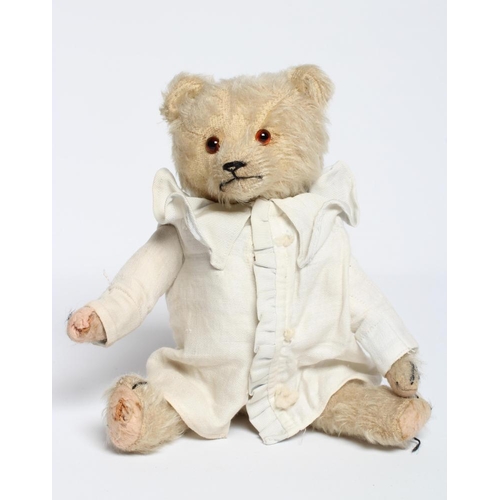 185 - A rare pre-war white teddy bear, with amber glass eyes, sewn nose, white plush, straw filling, felt ... 