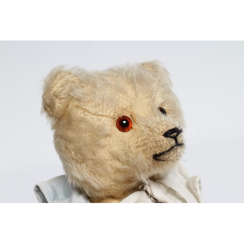 185 - A rare pre-war white teddy bear, with amber glass eyes, sewn nose, white plush, straw filling, felt ... 