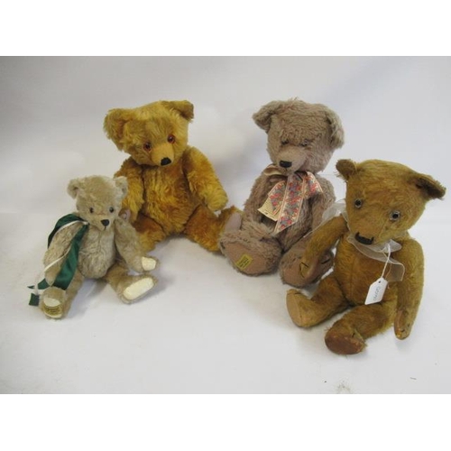 193 - Four teddy bears, comprising a vintage straw filled teddy with clear glass eyes, orange plush and ca... 