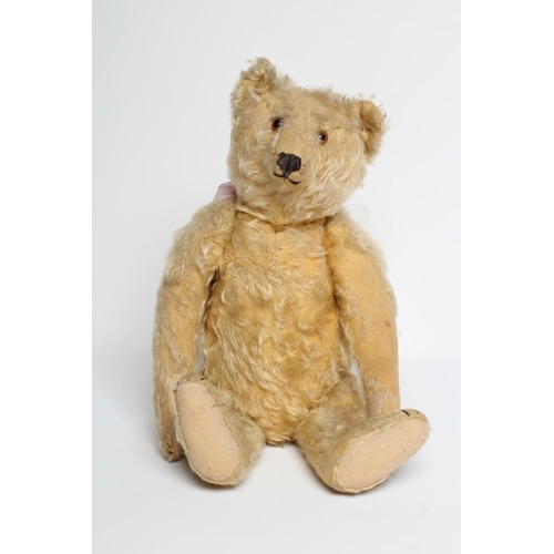 198 - An early Steiff teddy bear, with amber glass eyes, sewn nose, felt pads, orange plush and button to ... 