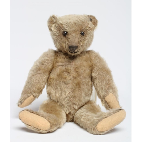 199 - An old Steiff teddy bear, with black button eyes, sewn nose, replaced felt pads, light orange plush ... 