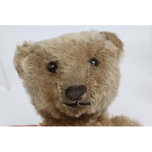 199 - An old Steiff teddy bear, with black button eyes, sewn nose, replaced felt pads, light orange plush ... 