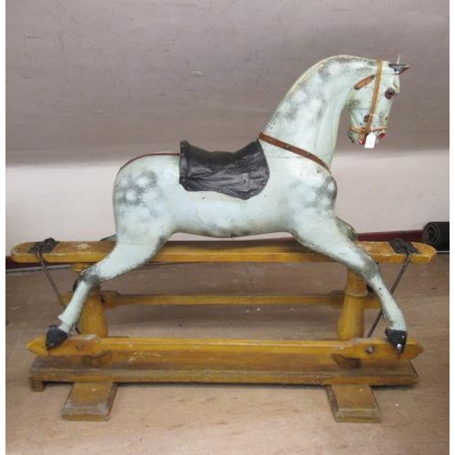 226 - A Victorian rocking horse, of carved wood construction, with mild head tilt, glass eyes, dappled gre... 