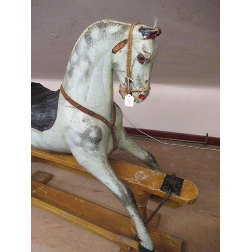 226 - A Victorian rocking horse, of carved wood construction, with mild head tilt, glass eyes, dappled gre... 