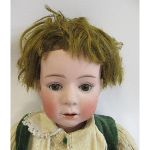 24 - A Heubach bisque socket head boy doll, with brown glass sleeping eyes, open mouth, two applied teeth... 