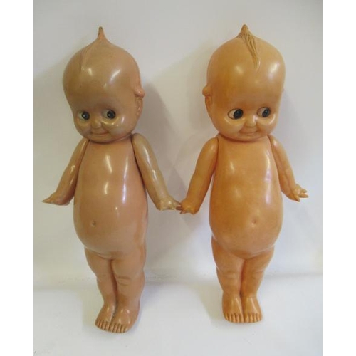 26 - A pair of large celluloid Kewpie dolls, with sideways glancing eyes and jointed shoulders, 21