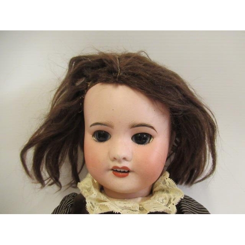 27 - An SFBJ bisque socket head doll, with brown glass sleeping eyes, open mouth, teeth, brown wig, wood ... 