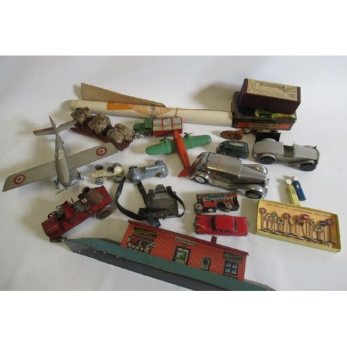 485 - Tinplate toys comprising aircraft, cars, railway station and Dinky road traffic signs, some rusting ... 