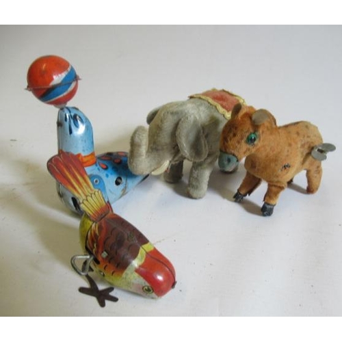 486 - Four clockwork tin animals comprising walking elephant, donkey, sea lion and small bird, F (Est. plu... 