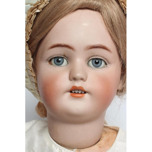 6 - A Simon & Halbig bisque socket head doll, with blue glass sleeping eyes, open mouth, moulded teeth, ... 