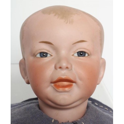 67 - An S.F.B.J. bisque head character boy doll, with blue glass fixed eyes, moulded open mouth, painted ... 