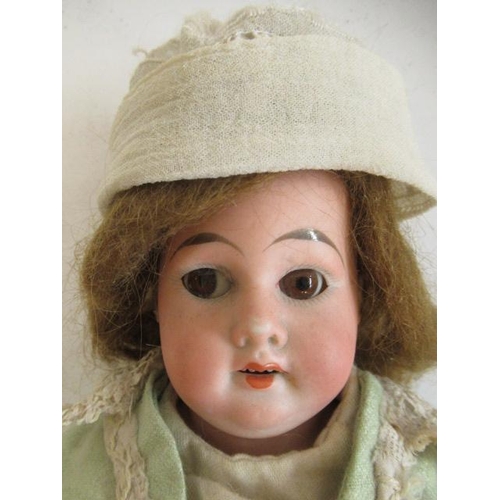 7 - An Armand Marseille bisque shoulder head doll, with brown glass fixed eyes, open mouth, teeth, compo... 