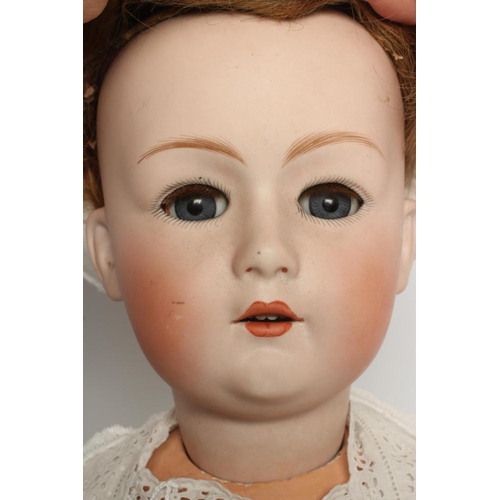 81 - A Gebruder Heubach bisque socket head doll, with blue glass sleeping eyes, open mouth, teeth, auburn... 