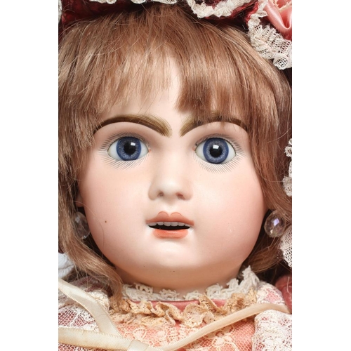 82 - A Jumeau bisque socket head doll, with blue glass fixed eyes, open mouth, teeth, pierced ears, wood ... 