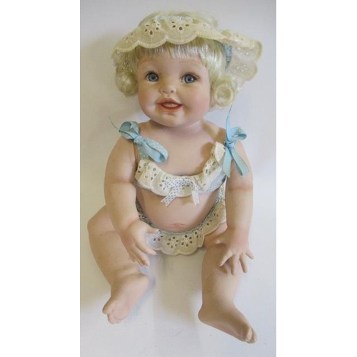 84 - Five Ashton Drake baby dolls, all ceramic with jointed necks, shoulders and hips, one in a bath tub,... 