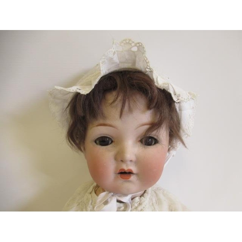 85 - A Gebruder Heubach bisque socket head doll, with brown glass sleeping eyes, open mouth, brown wig, w... 