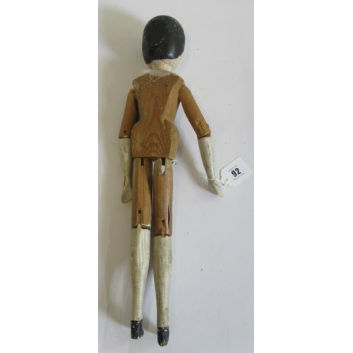 92 - A large Victorian peg doll, of all wood construction with painted face and hair, painted lower limbs... 