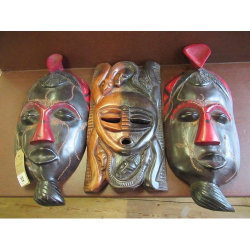 12 - THREE WOODEN AFRICAN MASKS