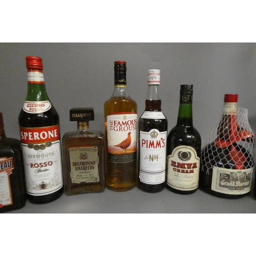 23 - A quantity of mixed spirits & liqueurs, including 1 litre Famous Grouse, 1 litre Grand Marnier, 1 bo... 