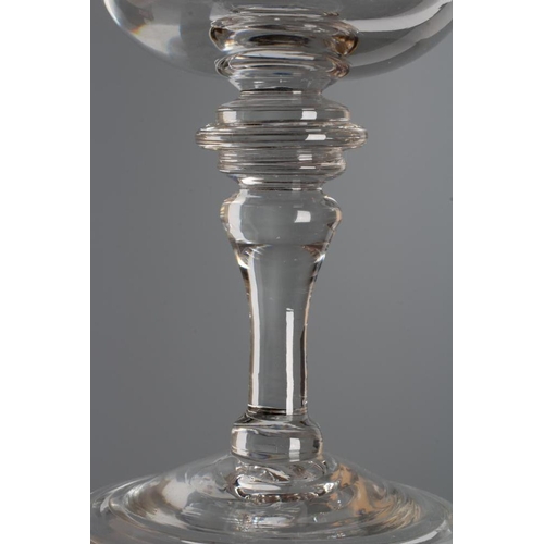 120 - A MEAD GLASS, early 18th century, the plain cup bowl issuing from a triple ringed annular top knop o... 