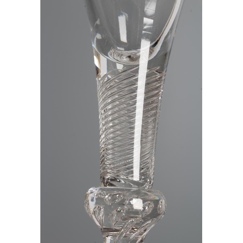 122 - A WINE GLASS, mid 18th century, the drawn trumpet bowl on a multiple spiral air twist stem with tear... 