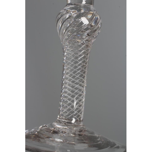 134 - A WINE GLASS, mid 18th century, the bell bowl issuing from an inverted baluster multiple spiral air ... 