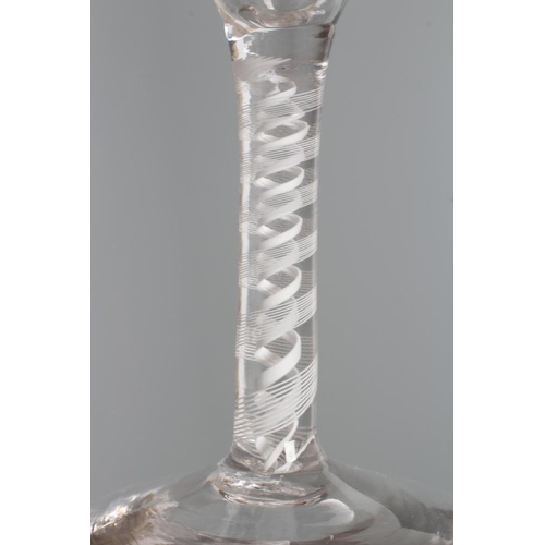 135 - A GLASS ALE FLUTE, mid 18th century, the round funnel bowl engraved with hops and barley on a multi ... 