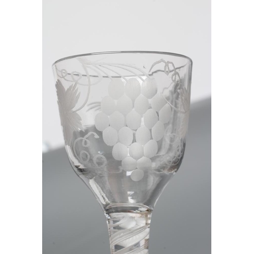 138 - A WINE GLASS, mid 18th century, the ogee bowl engraved with fruiting vine and a bird in flight on an... 