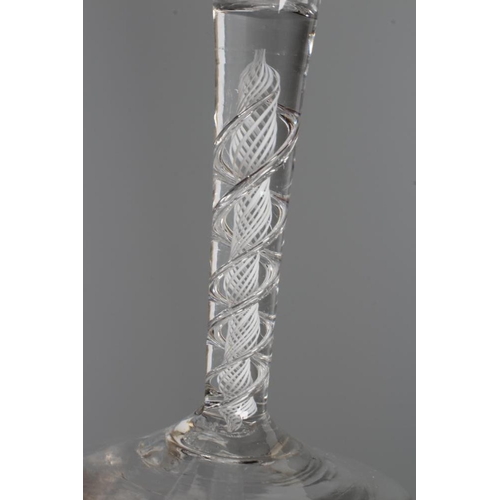 141 - A GLASS ALE FLUTE, mid 18th century, the plain trumpet bowl on a mixed twist stem with a multi-ply s... 