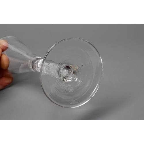 141 - A GLASS ALE FLUTE, mid 18th century, the plain trumpet bowl on a mixed twist stem with a multi-ply s... 