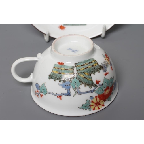 28 - A MEISSEN PORCELAIN TEA CUP AND SAUCER, 19th century, painted in the Kakiemon palette with an exotic... 