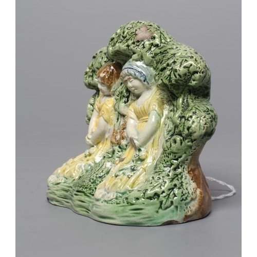 30 - A STAFFORDSHIRE PRATTWARE SLIP CAST GROUP, early 19th century, modelled as the Babes in the Wood, bo... 