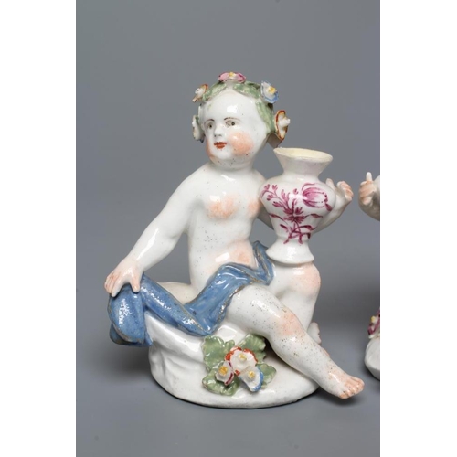 35 - A PAIR OF BOW PORCELAIN PUTTI, c.1760, modelled naked with flower garlands in their hair, seated and... 