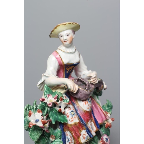 37 - A BOW PORCELAIN FIGURE, c.1760, modelled as Columbine, seated and wearing colourful clothing, playin... 