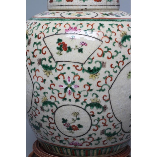 5 - A CHINESE JAR AND COVER of ovoid form, painted in colours with two quatrefoil panels enclosing exoti... 