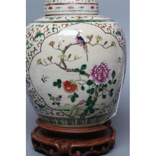 5 - A CHINESE JAR AND COVER of ovoid form, painted in colours with two quatrefoil panels enclosing exoti... 