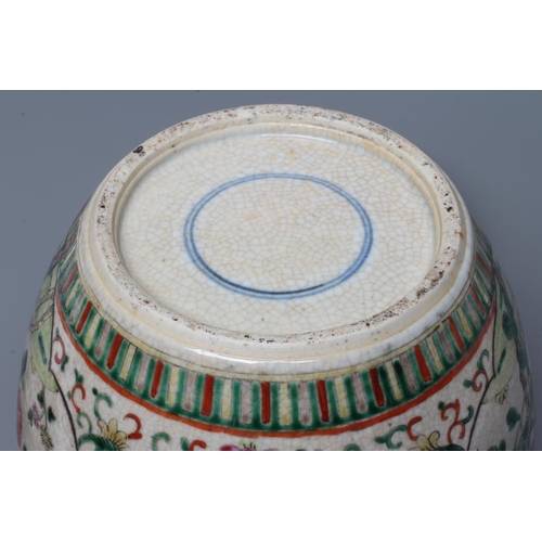 5 - A CHINESE JAR AND COVER of ovoid form, painted in colours with two quatrefoil panels enclosing exoti... 