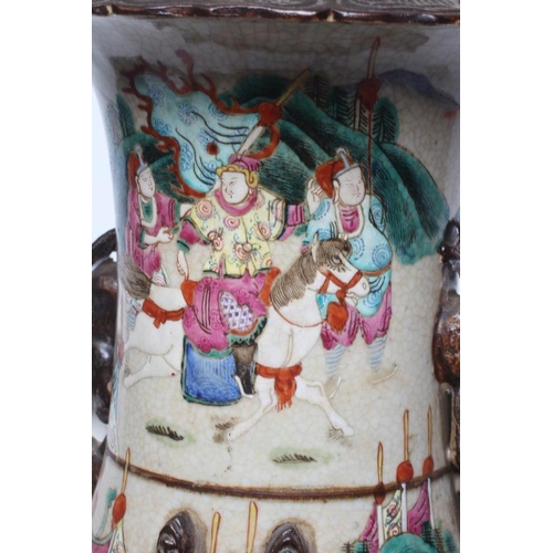 6 - A CHINESE ALCOVE VASE of rouleau form with shi-shi handles and applied salamanders to the shoulders ... 