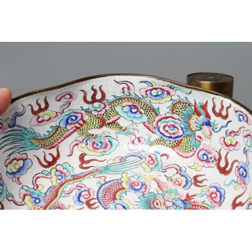 652 - A CANTON ENAMEL BOWL of lobed circular form, painted in bright colours with dragons on a white groun... 