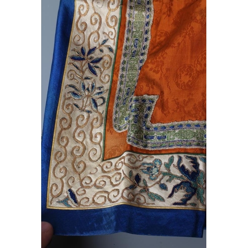 654 - A CHINESE SILK SKIRT PANEL, the burnt orange gores with bright blue seams, with blue and gold thread... 