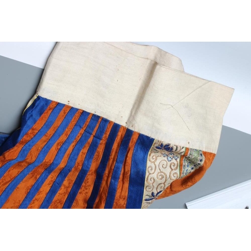 654 - A CHINESE SILK SKIRT PANEL, the burnt orange gores with bright blue seams, with blue and gold thread... 