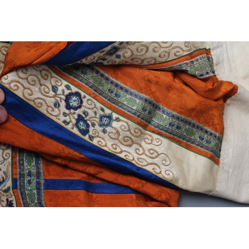 654 - A CHINESE SILK SKIRT PANEL, the burnt orange gores with bright blue seams, with blue and gold thread... 