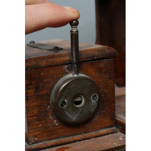 659 - AN EDWARDIAN OAK NOVELTY SMOKERS COMPANION, modelled as a vintage car with cast brass wheels, the hi... 