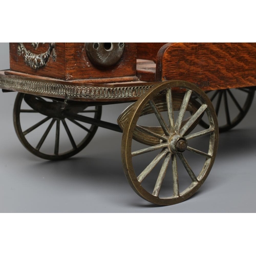 659 - AN EDWARDIAN OAK NOVELTY SMOKERS COMPANION, modelled as a vintage car with cast brass wheels, the hi... 