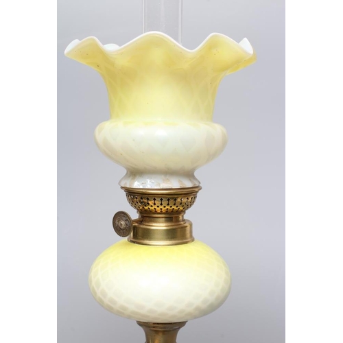 664 - A SMALL VICTORIAN BRASS OIL LAMP, the yellow and white satin glass ball shaped shade and reservoir w... 