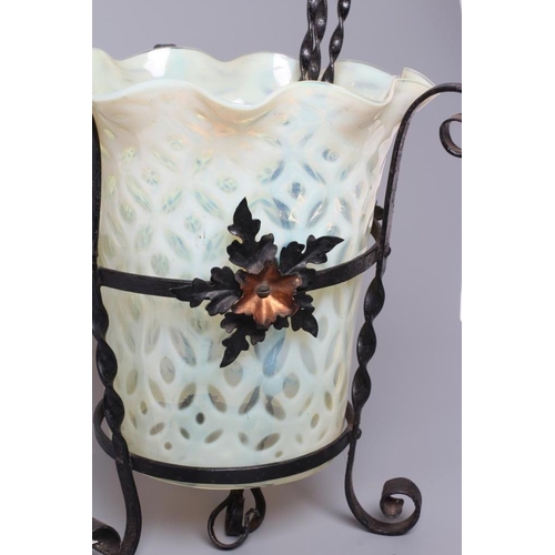 665 - AN ART NOUVEAU WROUGHT IRON LANTERN, the wrythen turned frame with three applied anodised copper flo... 