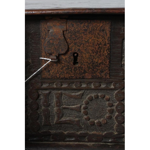 669 - AN OAK BOARDED BOX, c.1700, the hinged lid with punched banding, the fascia carved with trailing fol... 